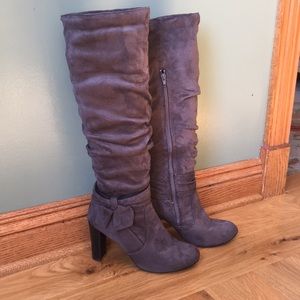 Grey suede high heeled boots with bow.